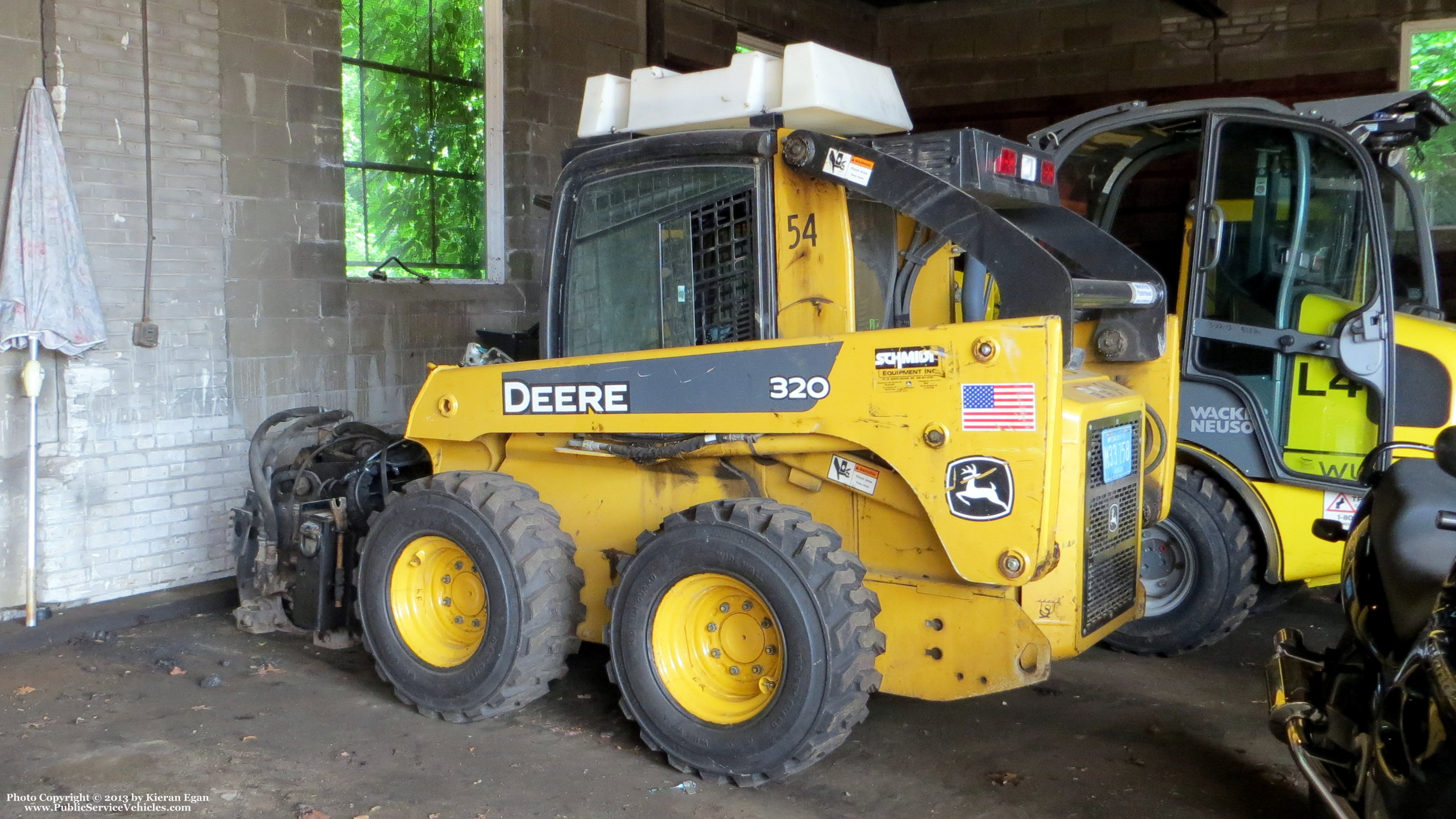 A photo  of Norwood Public Works
            Skidsteer 54, a 2009 John Deere 320             taken by Kieran Egan